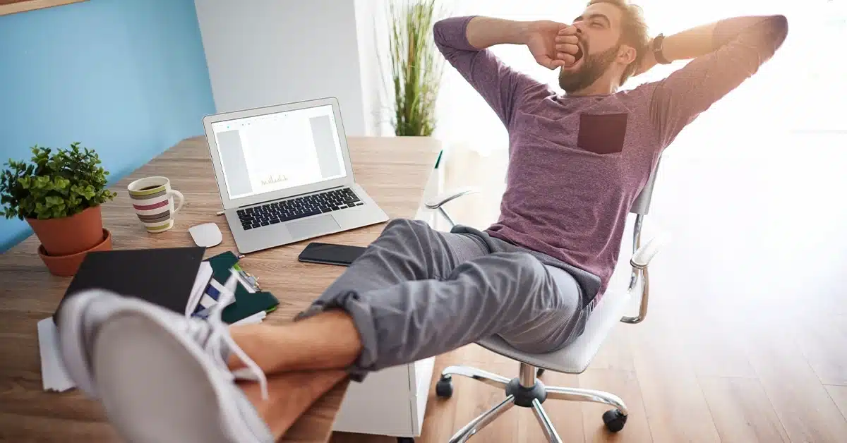 A tired person resting their head on a desk after long hours of work, symbolizing the importance of achieving work-life balance.